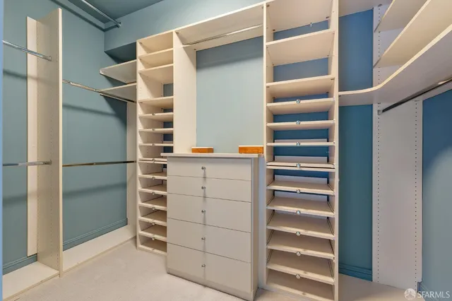 a view of walk in closet with empty racks