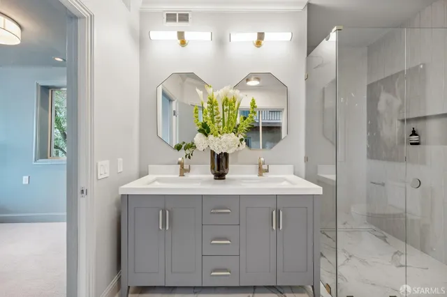 a bathroom with a double vanity sink and a mirror