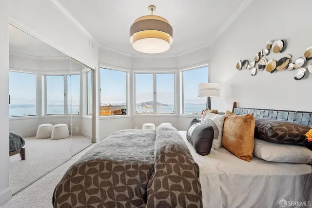 a bedroom with a bed and a painting on the wall