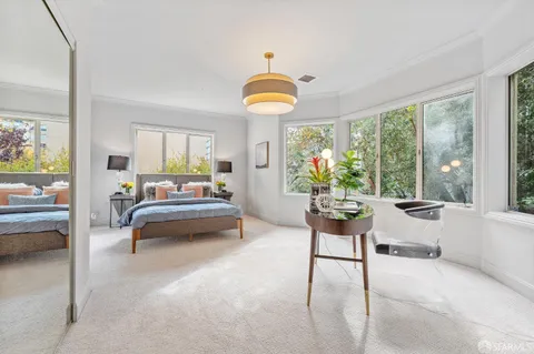 a bedroom with furniture and a chandelier