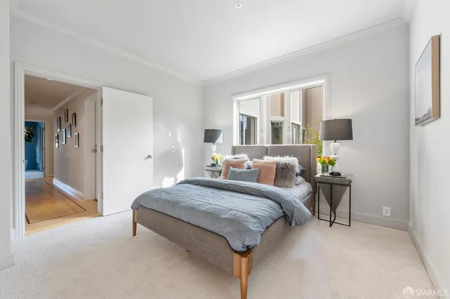 a spacious bedroom with a bed and large mirror