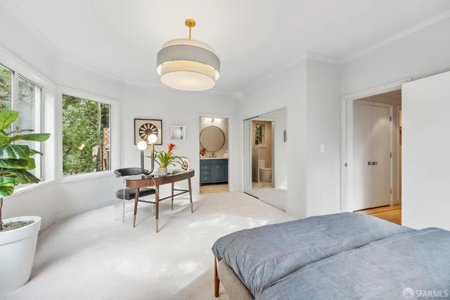 a bedroom with a bed and a large window