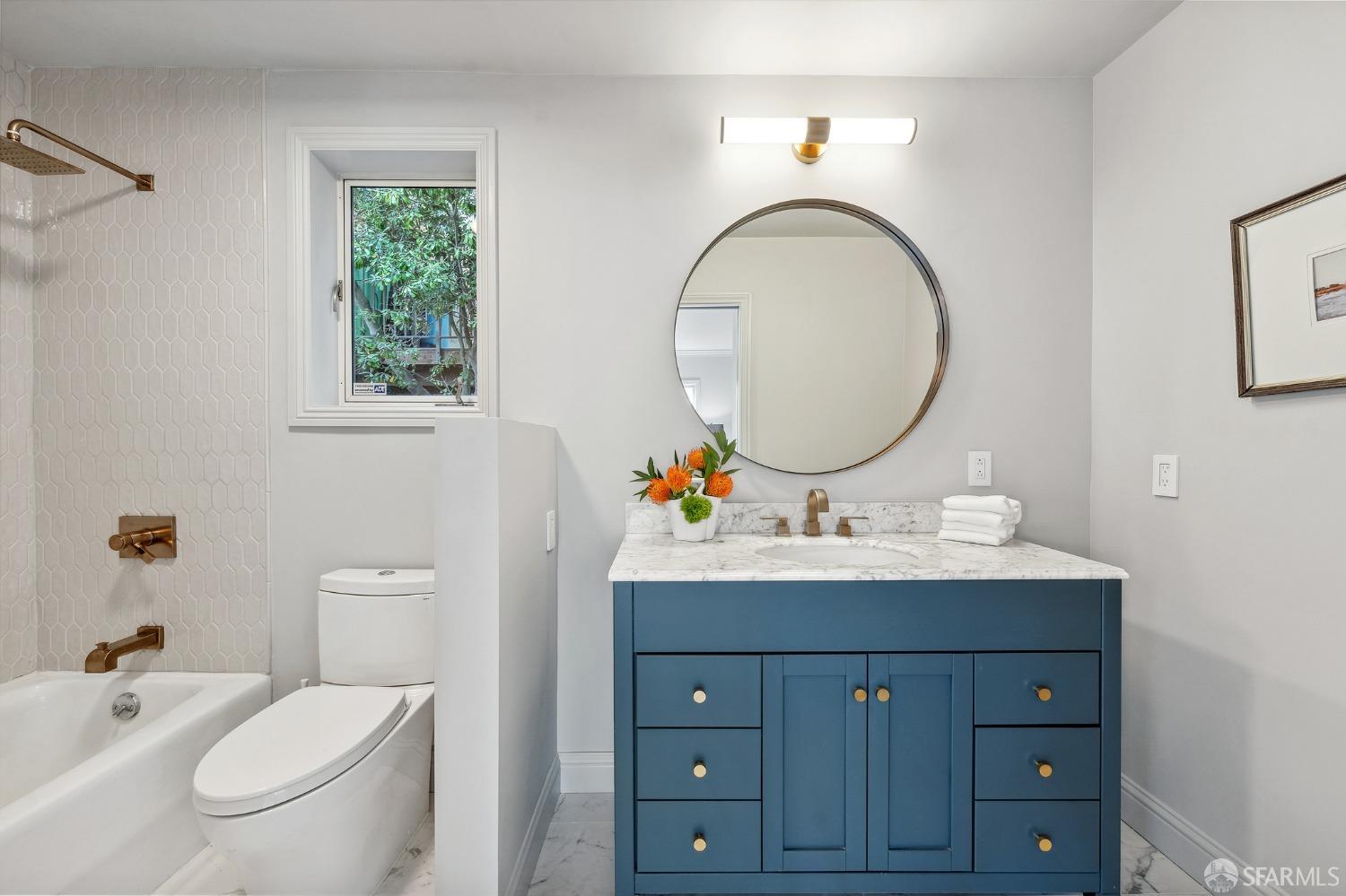 900 Green Street, Unit 600 San Francisco, CA 94133 - Photo 48 of 50 a bathroom with a toilet a sink and a mirror