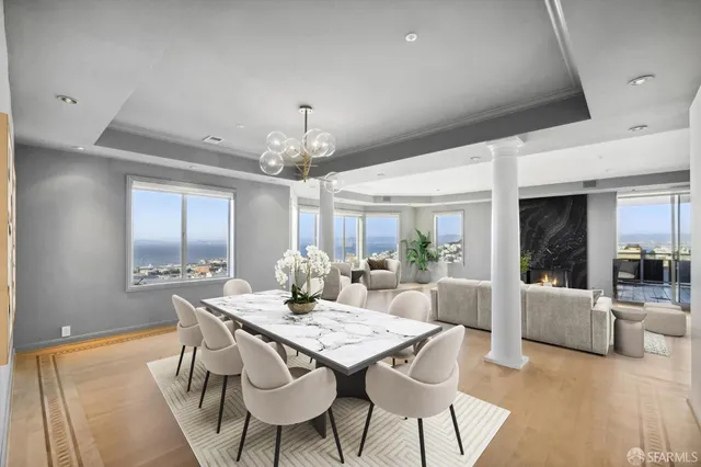 a view of a dining room with furniture wooden floor and chandelier