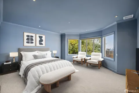 a bedroom with a bed and glass window