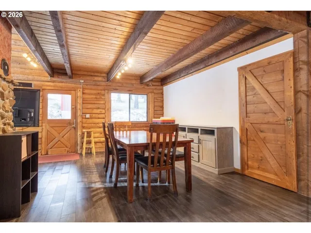 a dining room with furniture window and wooden floor
