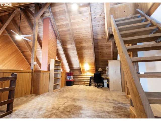 a view of a livingroom with furniture and a window