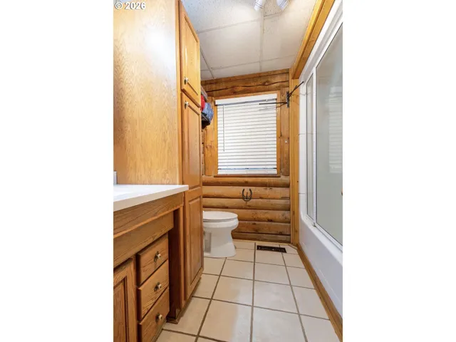 a bedroom with a bed mirror and a desk