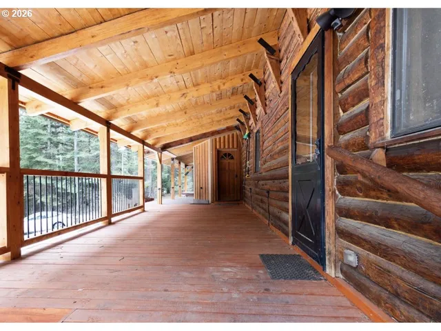 a view of a porch with wooden floor and fence