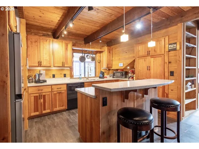 a kitchen with stainless steel appliances granite countertop a sink and cabinets