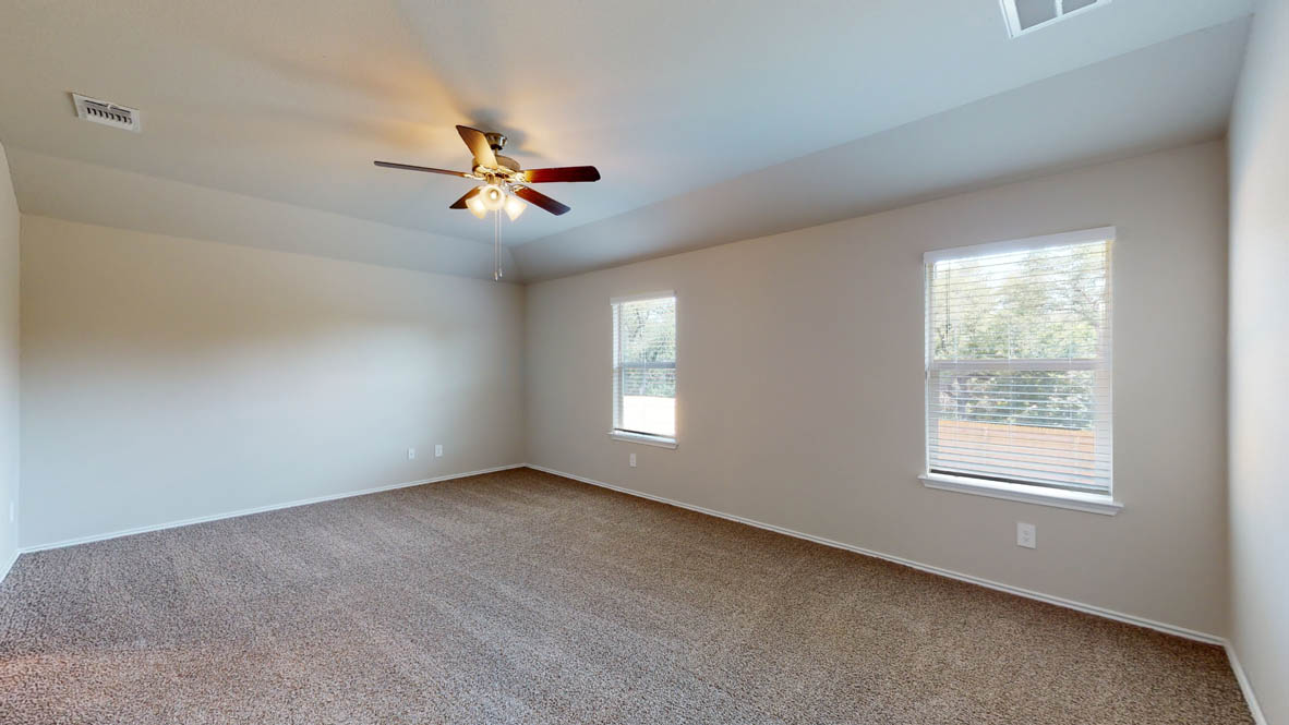 509 Hector Loop Georgetown, TX 78626 - Photo 14 of 31 A spacious, naturally illuminated room featuring warm carpeting and a modern ceiling fan for ultimate comfort.