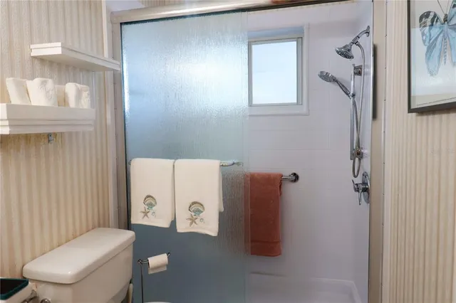 a white toilet sitting next to a bathroom sink