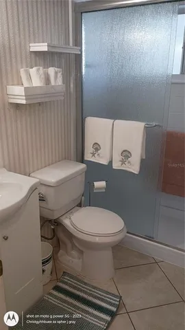 a white toilet sitting next to a bathroom sink