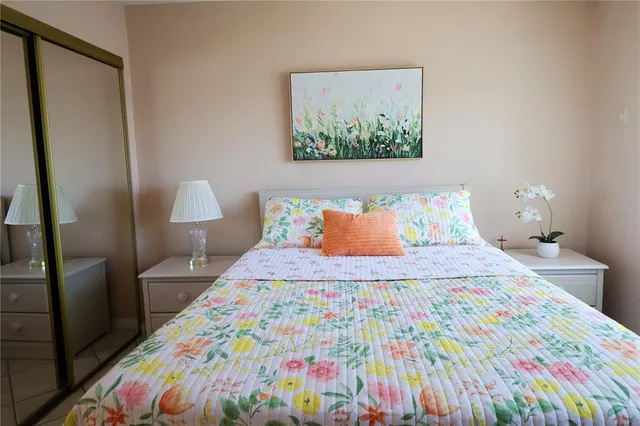 a bedroom with a bed and painting on the wall