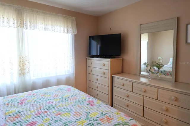 a bedroom with a bed and a television in it