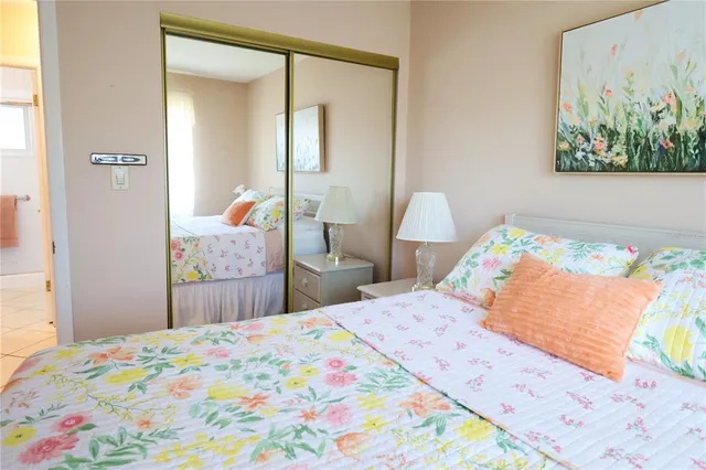 a bedroom with a bed and a painting on the wall