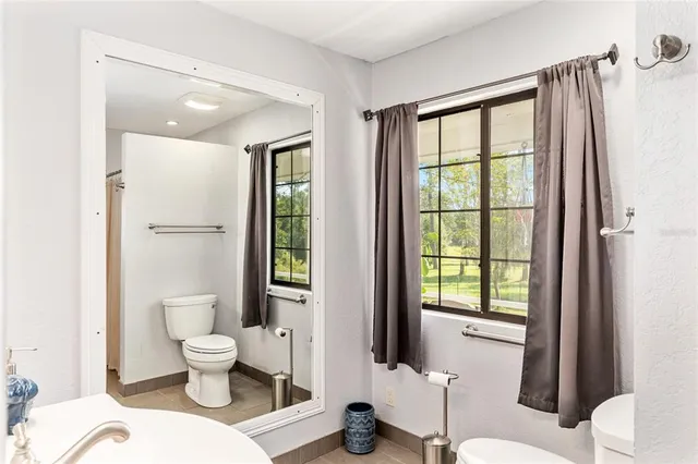 a bathroom with a sink mirror and vanity