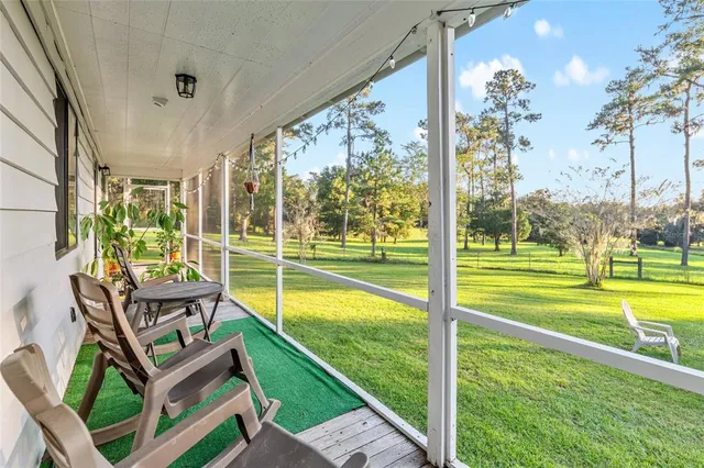 a view of a chair and table in backyard of the house