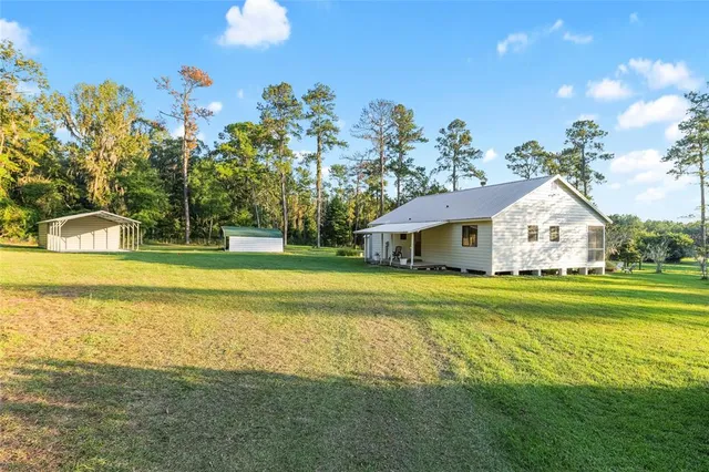 a front view of a house with a big yard