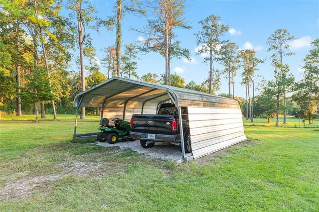 a view of yard with swimming pool and green space