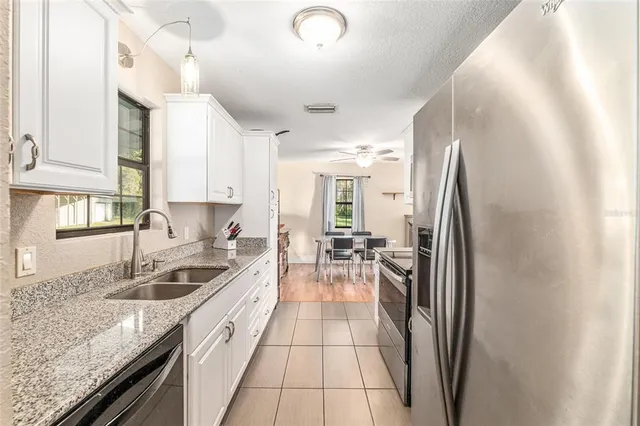 a kitchen with granite countertop a sink and a window