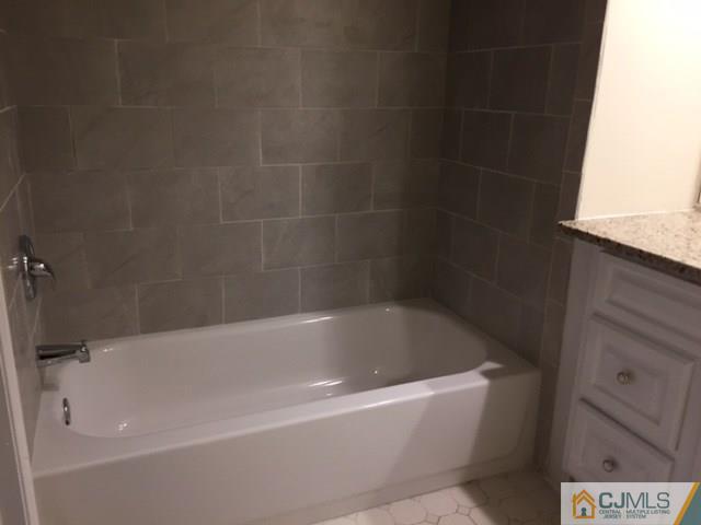 5001 Stonehedge Road, Unit 5001 Edison, NJ 08820 - Photo 13 of 13 a bathroom with a bathtub