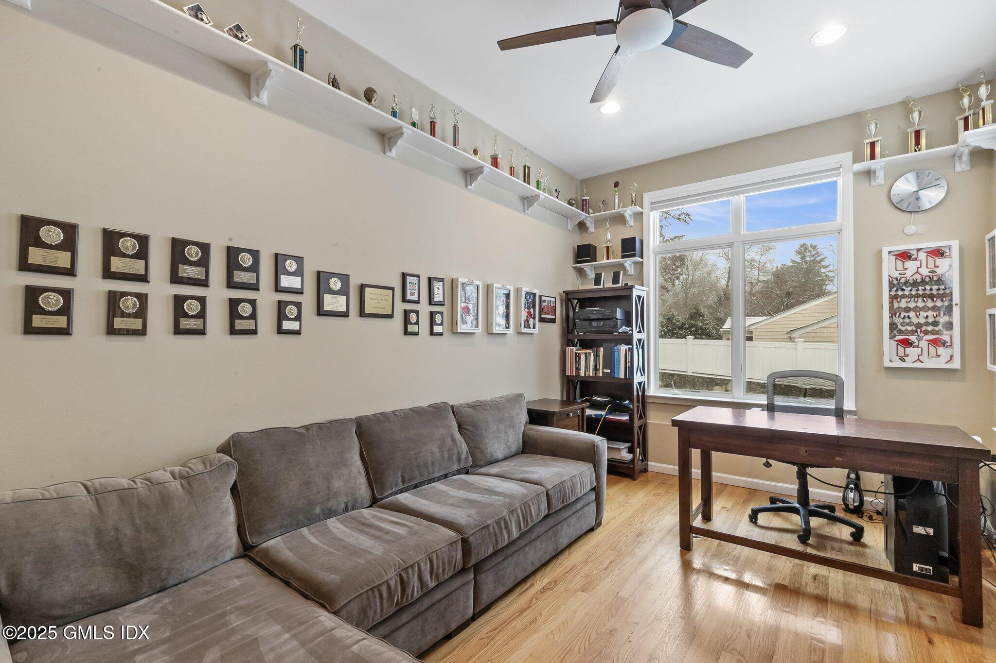 16 Elizabeth Lane Riverside, CT 06878 - Photo 15 of 38 a living room with furniture a flat screen tv and a wall painting