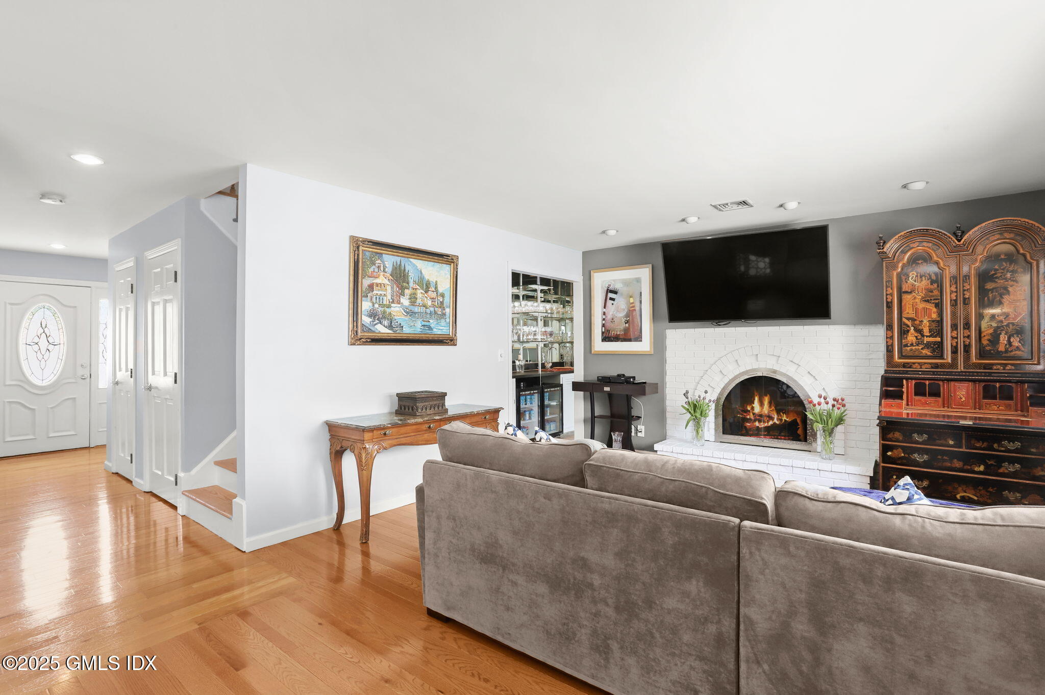 16 Elizabeth Lane Riverside, CT 06878 - Photo 5 of 38 a living room with furniture a fireplace and flat screen tv