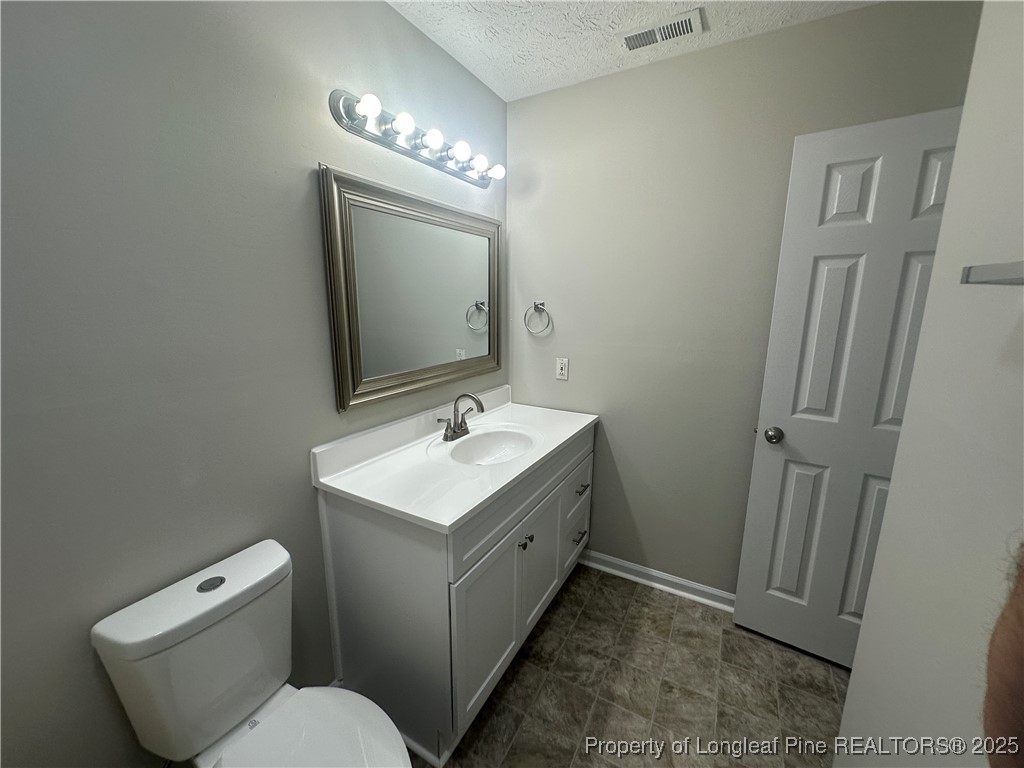 75 Tradewinds Drive Spring Lake, NC 28390 - Photo 14 of 26 a spacious bathroom with a toilet sink and mirror