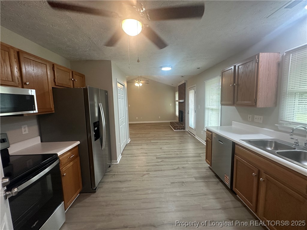 75 Tradewinds Drive Spring Lake, NC 28390 - Photo 7 of 26 a large kitchen with stainless steel appliances wooden cabinets and a stove