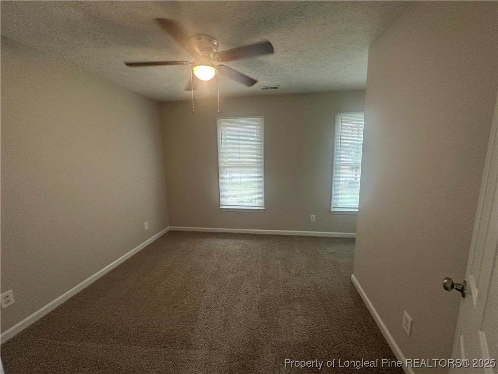 75 Tradewinds Drive Spring Lake, NC 28390 - Photo 10 of 26 an empty room with a window and a fan