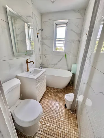 a kitchen with stainless steel appliances a stove a sink and a refrigerator