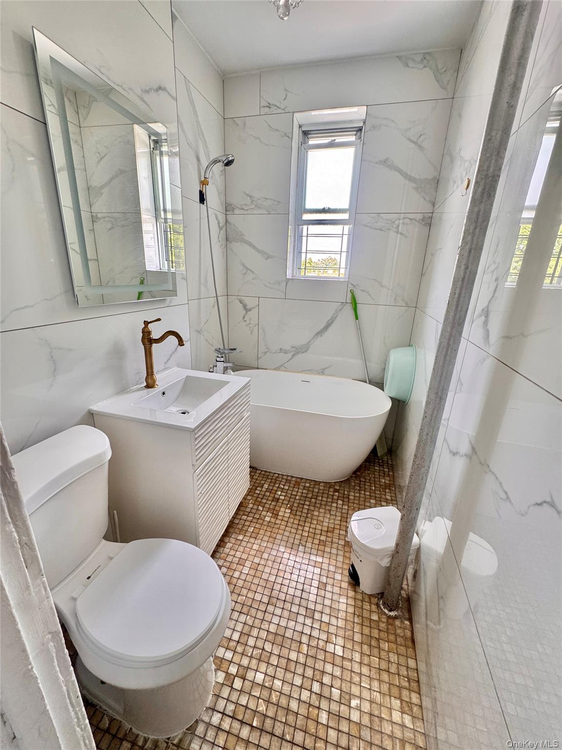 98-15 34th Avenue Queens, NY 11368 - Photo 16 of 41 a bathroom with a toilet a sink and a mirror