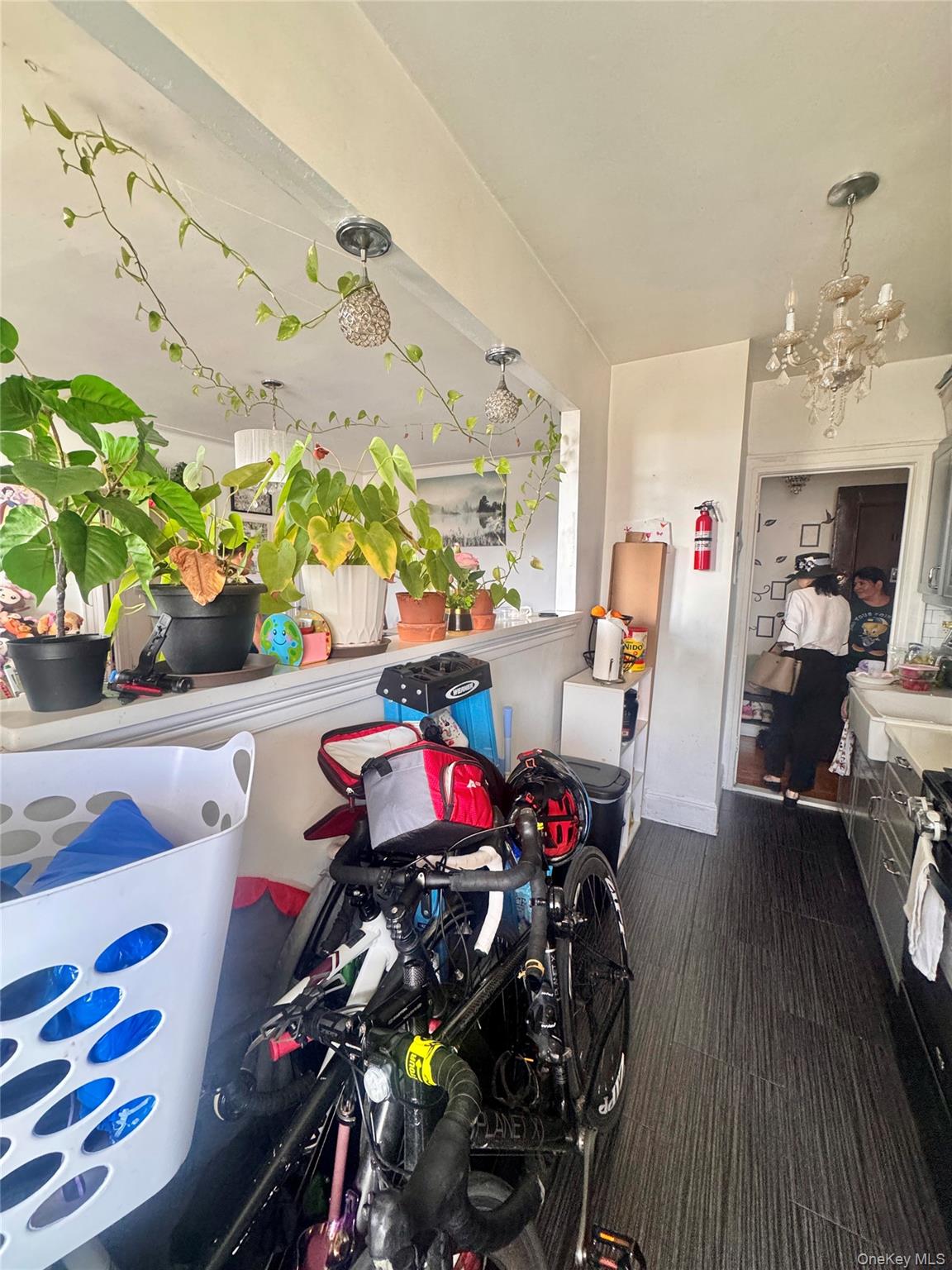 98-15 34th Avenue Queens, NY 11368 - Photo 17 of 41 a living room filled with furniture and a chandelier