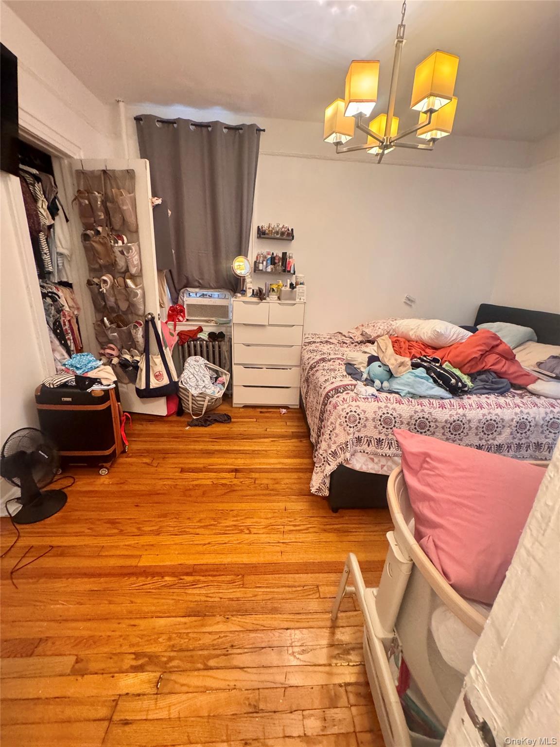 98-15 34th Avenue Queens, NY 11368 - Photo 39 of 41 a bedroom with bed and a flat tv screen on dresser