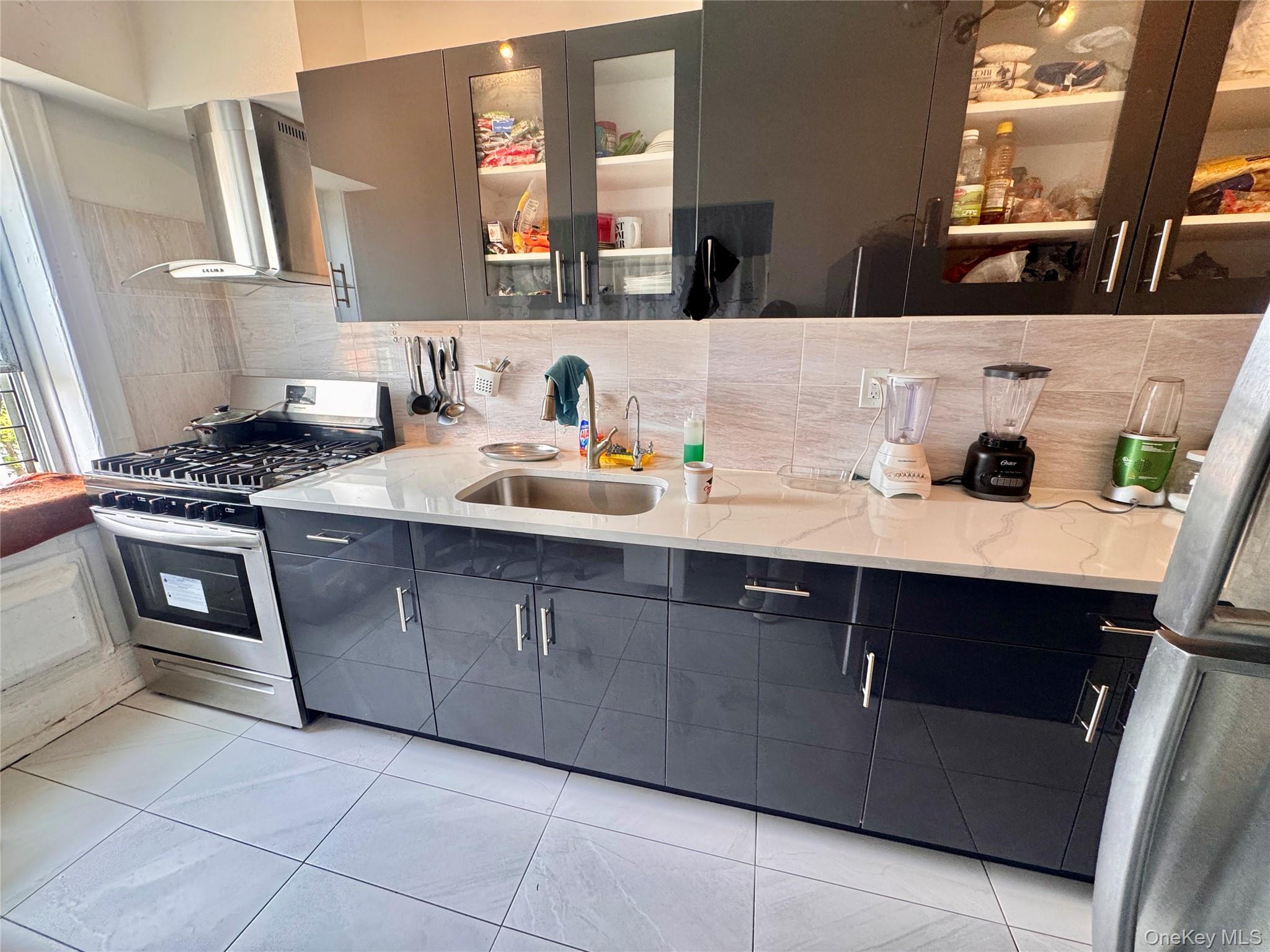 98-15 34th Avenue Queens, NY 11368 - Photo 10 of 41 a bathroom with a sink and a mirror