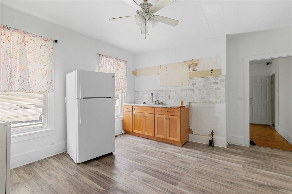 1 Ely Street Worcester, MA 01610 - Photo 12 of 25 a kitchen with stainless steel appliances a refrigerator and a stove top oven