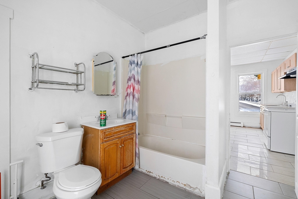 1 Ely Street Worcester, MA 01610 - Photo 17 of 25 a white toilet sitting next to a bath tub and a shower