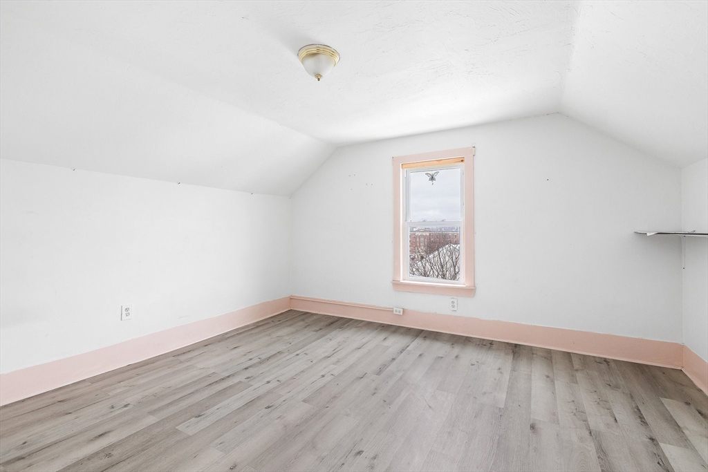 1 Ely Street Worcester, MA 01610 - Photo 20 of 25 an empty room with wooden floor and windows