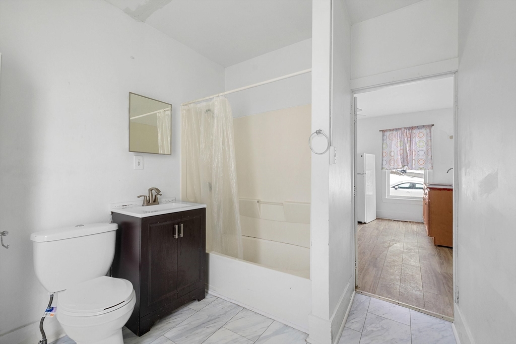 1 Ely Street Worcester, MA 01610 - Photo 8 of 25 a bathroom with a toilet a sink and shower