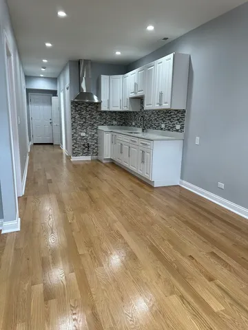 a large kitchen with stainless steel appliances granite countertop a granite counter tops and a stove