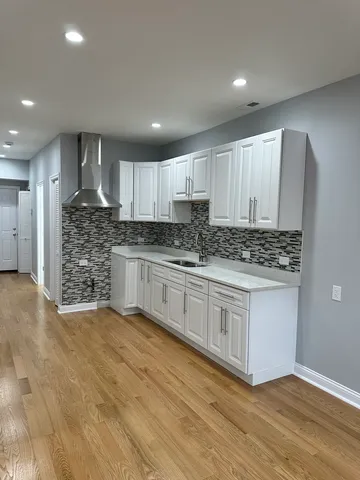 a kitchen with stainless steel appliances granite countertop a stove sink and cabinets
