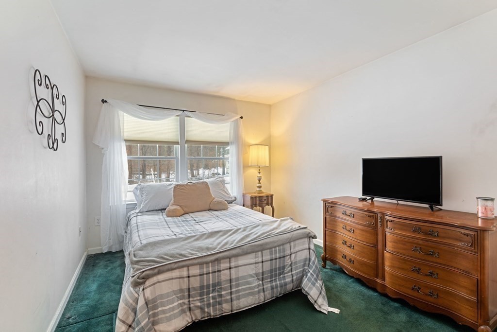 22 Oak Road Littleton, MA 01460 - Photo 11 of 42 a bedroom with a bed and flat screen tv