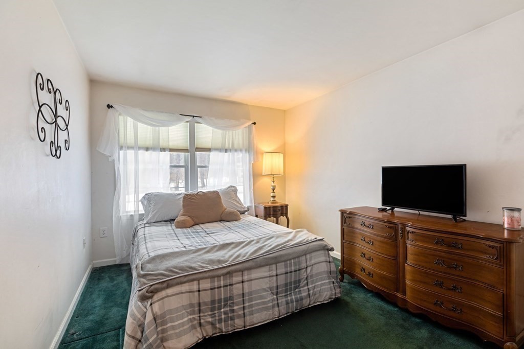 22 Oak Road Littleton, MA 01460 - Photo 13 of 42 a bedroom with a bed and flat screen tv