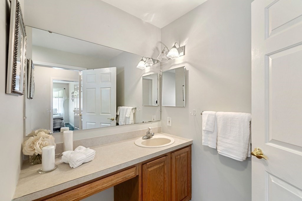 22 Oak Road Littleton, MA 01460 - Photo 14 of 42 a bathroom with a sink vanity granite tub and a mirror