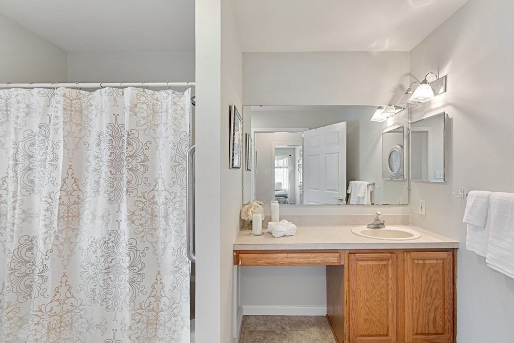 22 Oak Road Littleton, MA 01460 - Photo 15 of 42 a bathroom with a double vanity sink and a mirror