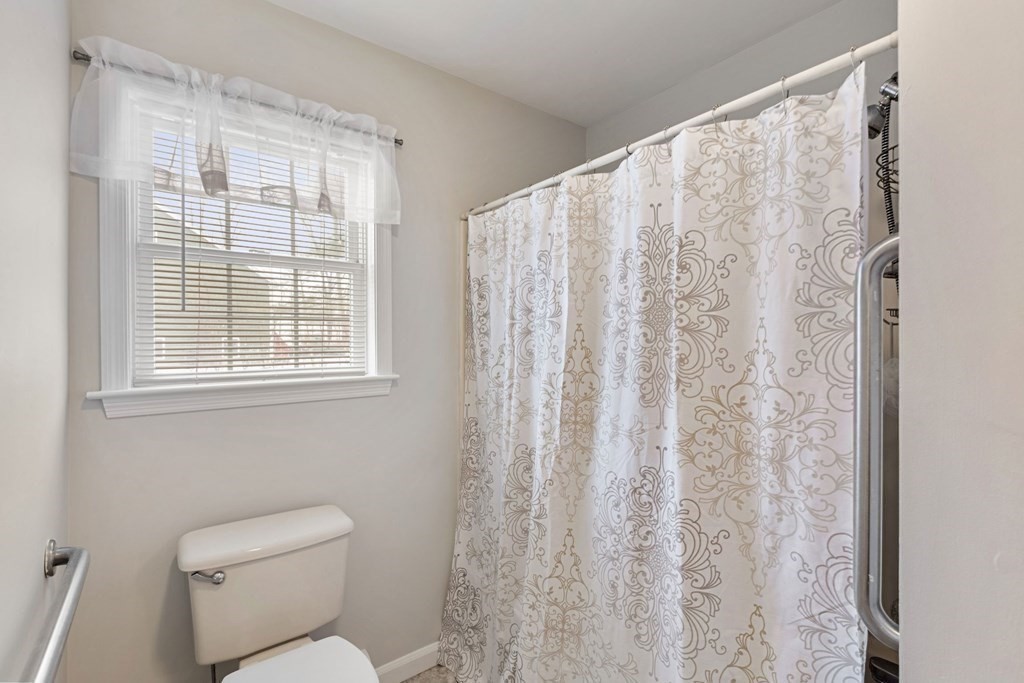 22 Oak Road Littleton, MA 01460 - Photo 16 of 42 a bathroom with a toilet and a shower curtain
