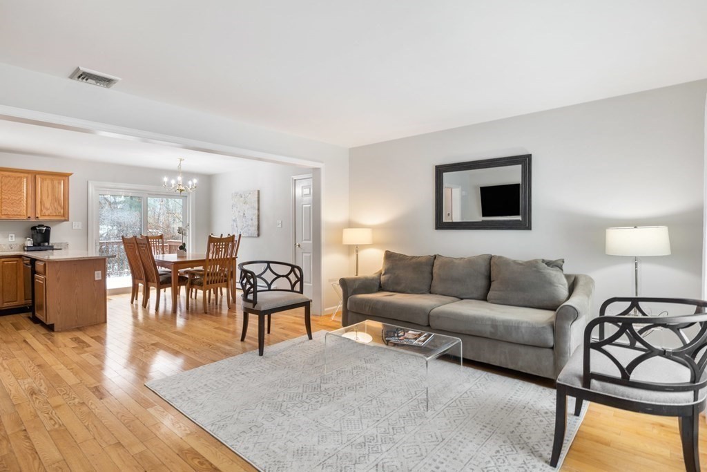 22 Oak Road Littleton, MA 01460 - Photo 2 of 42 a living room with furniture kitchen view and a wooden floor
