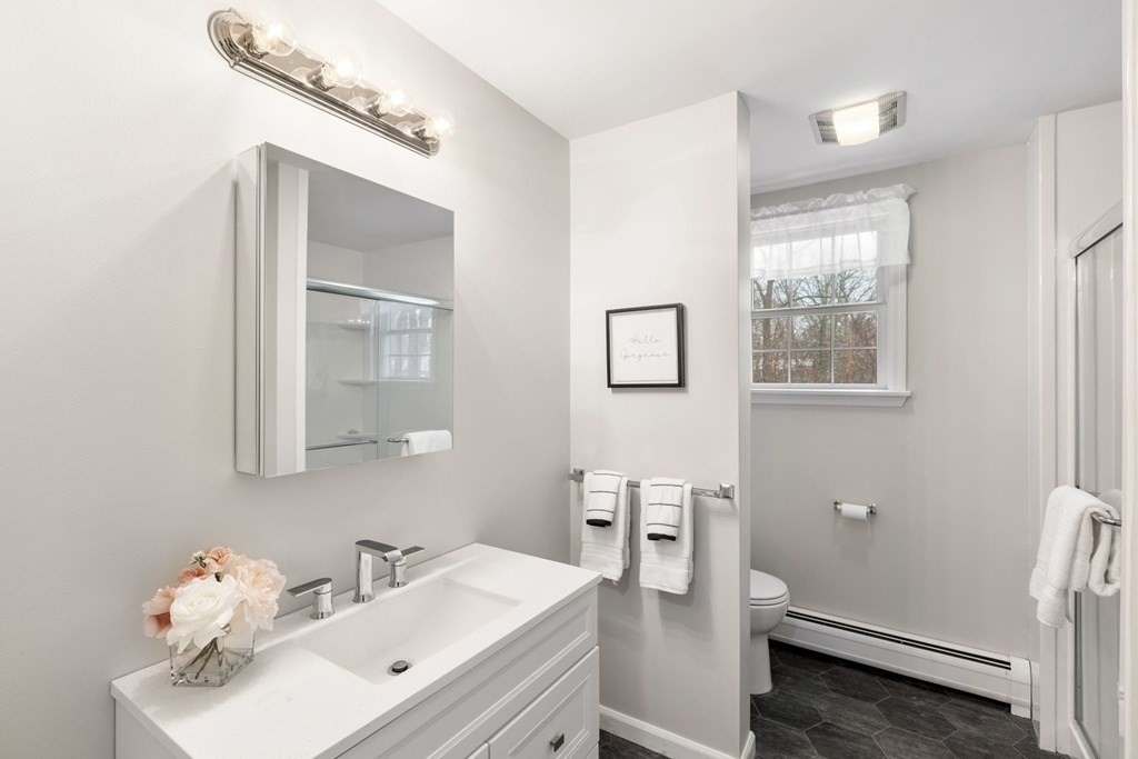 22 Oak Road Littleton, MA 01460 - Photo 23 of 42 a bathroom with a sink mirror and vanity