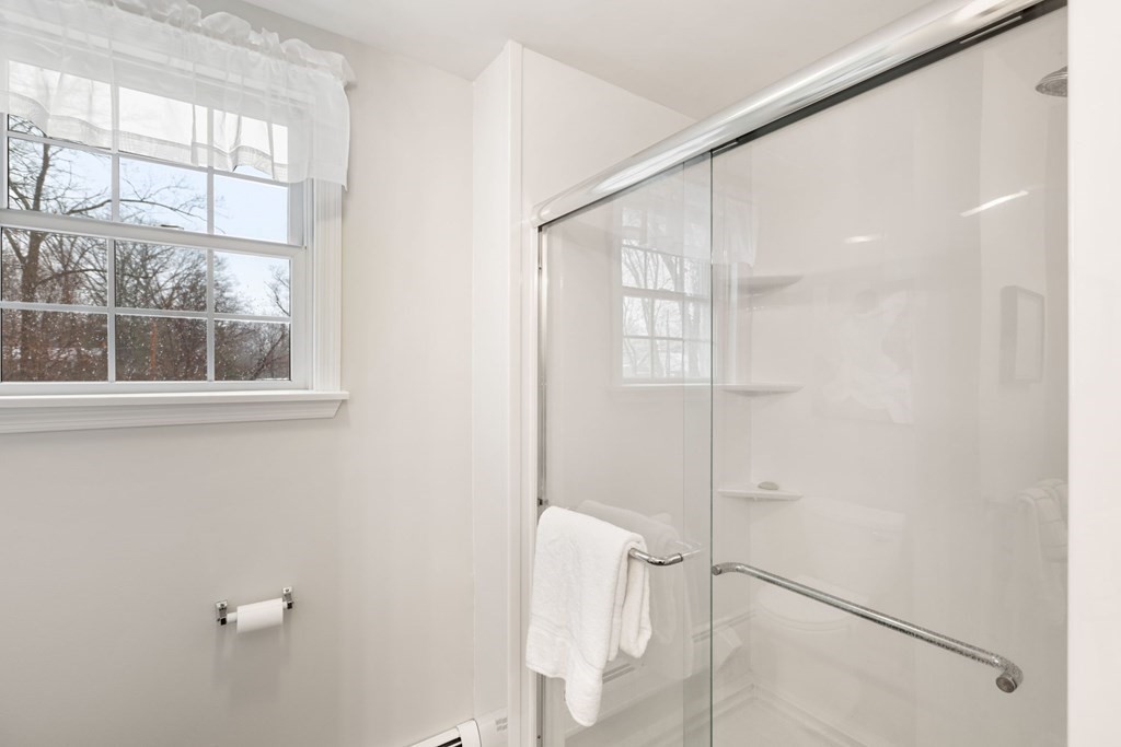22 Oak Road Littleton, MA 01460 - Photo 24 of 42 a bathroom with a glass shower door